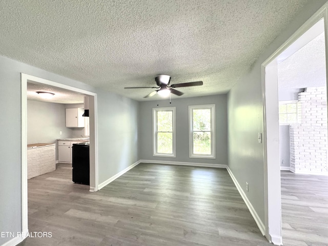 914 S 13th St, Lafollette, TN 37766 - unfurnished living room with ceiling fan, wood finished floors, and a textured ceiling