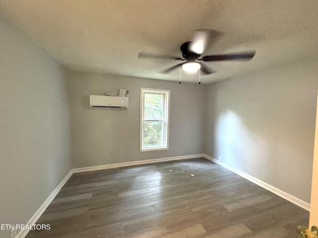 914 S 13th St, Lafollette, TN 37766 - spare room featuring a wall mounted AC, dark wood-type flooring, ceiling fan, and a textured ceiling