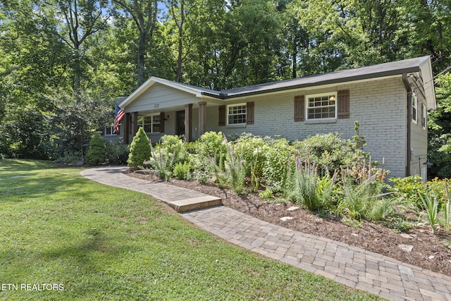 1521 Aldenwood Ln, Knoxville, TN 37919 - view of front of house with a front lawn, brick siding, and covered porch
