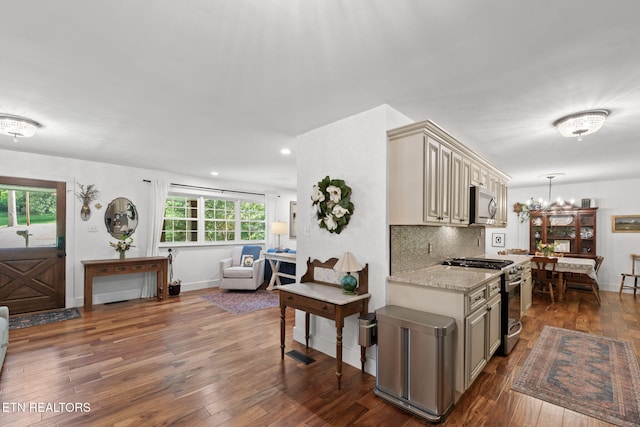 1521 Aldenwood Ln, Knoxville, TN 37919 - kitchen featuring appliances with stainless steel finishes, cream cabinets, dark wood-type flooring, backsplash, and light stone counters