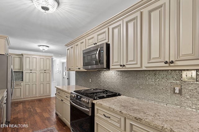 1521 Aldenwood Ln, Knoxville, TN 37919 - kitchen featuring cream cabinetry, appliances with stainless steel finishes, and decorative backsplash