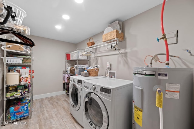 1521 Aldenwood Ln, Knoxville, TN 37919 - laundry area with electric water heater, light wood-style flooring, washer and clothes dryer, and recessed lighting