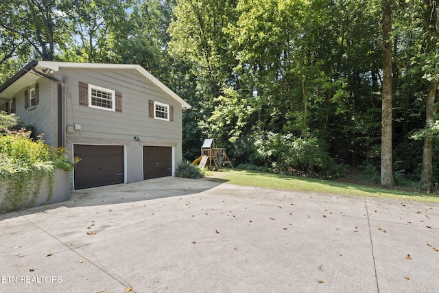 1521 Aldenwood Ln, Knoxville, TN 37919 - view of home's exterior featuring concrete driveway, an attached garage, and a playground