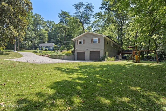 1521 Aldenwood Ln, Knoxville, TN 37919 - view of home's exterior with an attached garage, driveway, a yard, and view of scattered trees