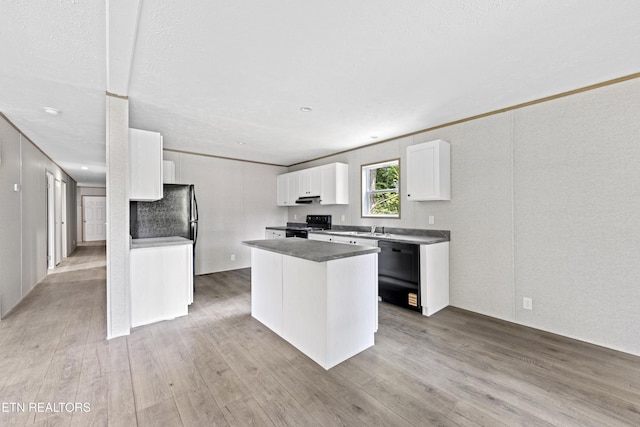 417 Cain Ave, Morristown, TN 37813 - kitchen with black appliances, white cabinets, light wood-style flooring, and a kitchen island