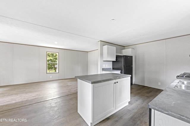 417 Cain Ave, Morristown, TN 37813 - kitchen featuring freestanding refrigerator, dark wood finished floors, white cabinets, a kitchen island, and open floor plan