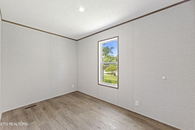 417 Cain Ave, Morristown, TN 37813 - unfurnished room with wood finished floors, ornamental molding, and a textured ceiling