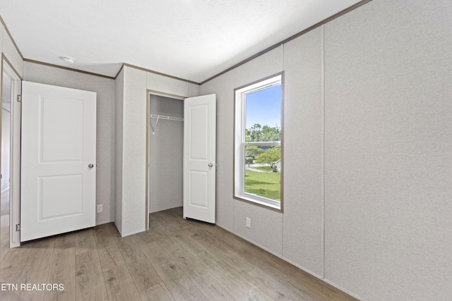 417 Cain Ave, Morristown, TN 37813 - unfurnished bedroom with light wood-type flooring, crown molding, and a closet