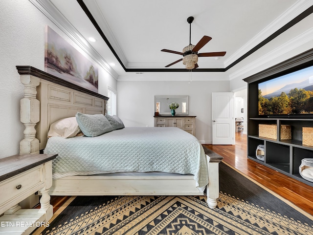 5728 Hickory Valley Rd, Heiskell, TN 37754 - bedroom featuring wood finished floors, ornamental molding, a tray ceiling, and a ceiling fan