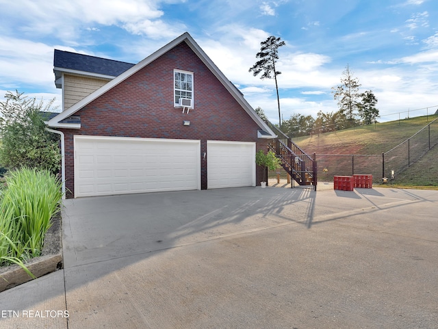 5728 Hickory Valley Rd, Heiskell, TN 37754 - view of property exterior with driveway, brick siding, an attached garage, and stairs