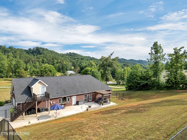 5728 Hickory Valley Rd, Heiskell, TN 37754 - back of house with a patio area, a view of trees, a fenced backyard, and a shingled roof