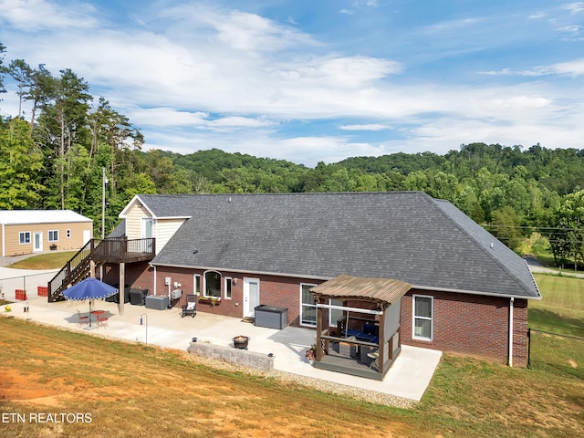 5728 Hickory Valley Rd, Heiskell, TN 37754 - back of house featuring brick siding, an outdoor fire pit, and a patio area