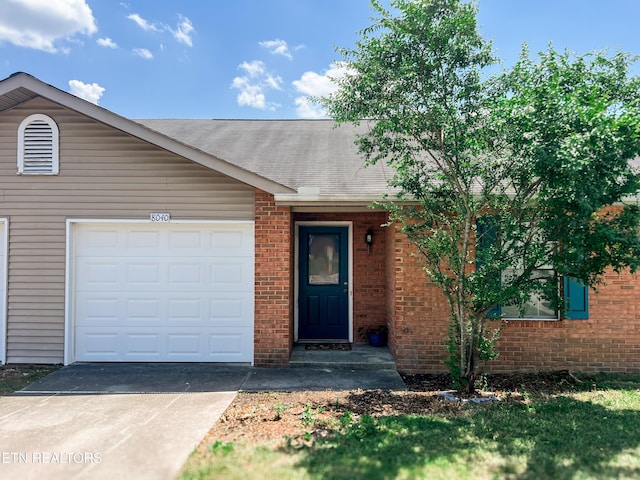 8040 Hansboro Way, Powell, TN 37849 - ranch-style house featuring driveway, brick siding, an attached garage, and a shingled roof