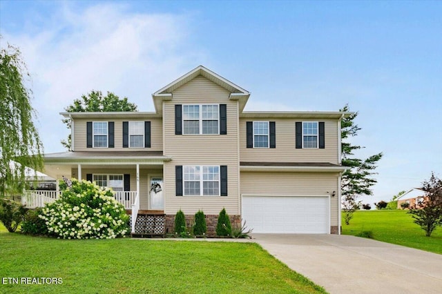 168 Thelma Cir, Jacksboro, TN 37757 - view of front of house with a garage, concrete driveway, a porch, and a front yard