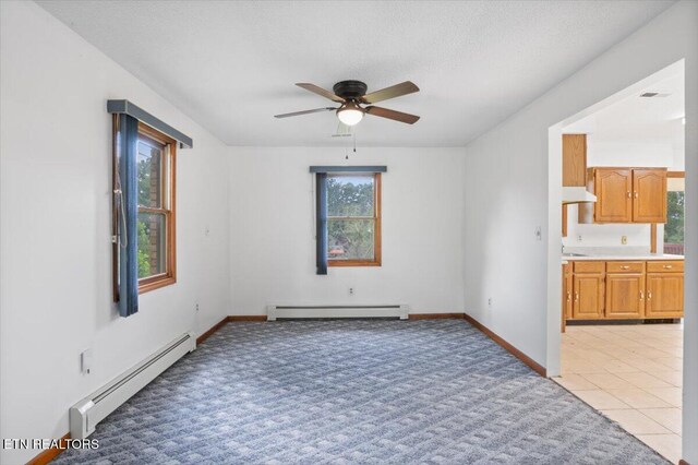 261 Lance Ln, Lafollette, TN 37766 - empty room featuring baseboard heating, a ceiling fan, and light carpet