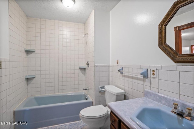 261 Lance Ln, Lafollette, TN 37766 - bathroom with tile walls, shower / tub combination, vanity, a textured ceiling, and wainscoting
