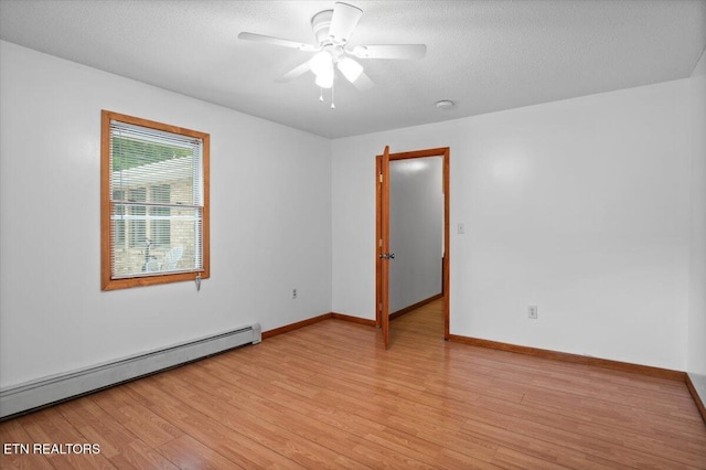 261 Lance Ln, Lafollette, TN 37766 - unfurnished room featuring a baseboard heating unit, light wood-style floors, ceiling fan, and a textured ceiling