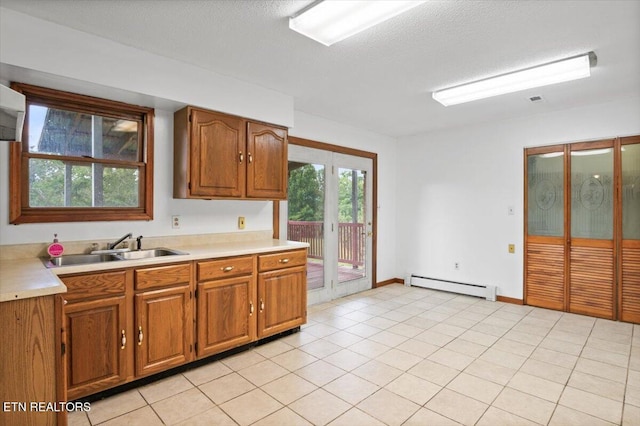 261 Lance Ln, Lafollette, TN 37766 - kitchen featuring a baseboard radiator, light countertops, brown cabinets, and light tile patterned flooring