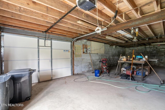261 Lance Ln, Lafollette, TN 37766 - garage featuring a garage door opener and concrete block wall