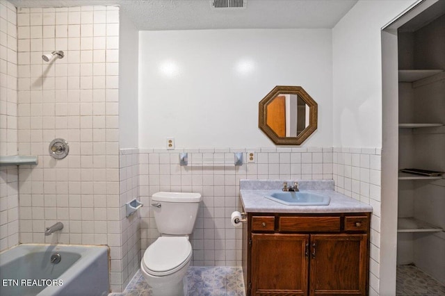 261 Lance Ln, Lafollette, TN 37766 - full bath with vanity, tile walls, wainscoting, and  shower combination