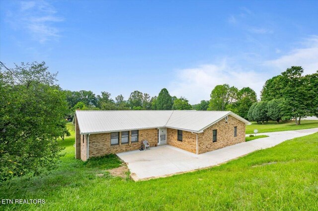261 Lance Ln, Lafollette, TN 37766 - ranch-style home featuring a patio, a front lawn, and a metal roof