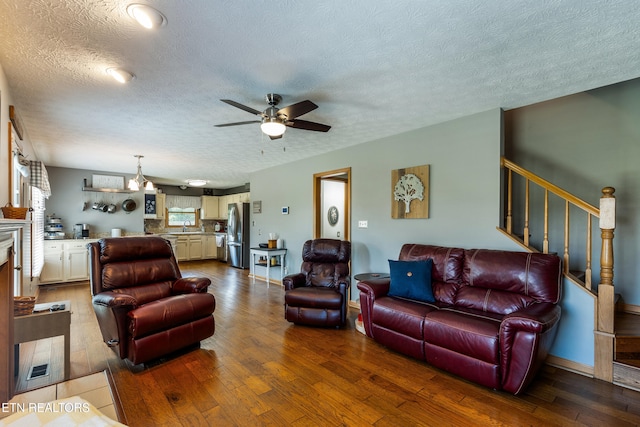 3938 Settlers Trl, Kodak, TN 37764 - living room with a textured ceiling, ceiling fan, wood-type flooring, and stairs