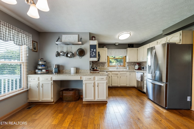 3938 Settlers Trl, Kodak, TN 37764 - kitchen featuring stainless steel appliances, plenty of natural light, dark wood-style floors, and a textured ceiling