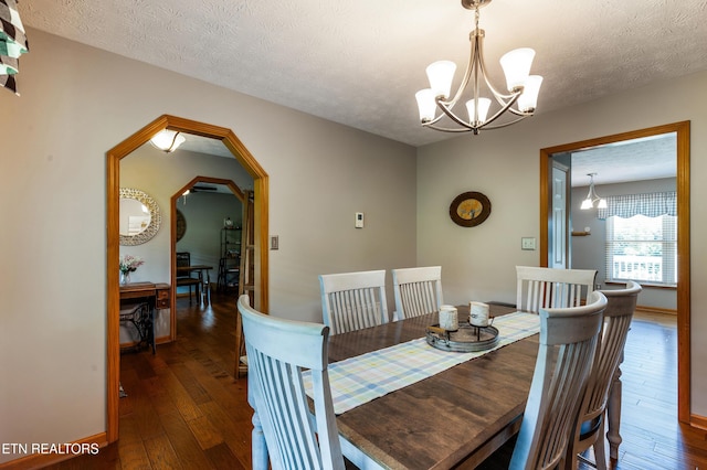 3938 Settlers Trl, Kodak, TN 37764 - dining room featuring a chandelier, hardwood / wood-style floors, a textured ceiling, and arched walkways