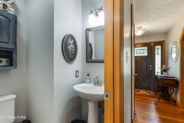 3938 Settlers Trl, Kodak, TN 37764 - bathroom featuring hardwood / wood-style floors and a textured ceiling