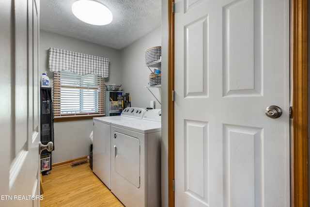 3938 Settlers Trl, Kodak, TN 37764 - laundry room with independent washer and dryer, light wood-style floors, and a textured ceiling
