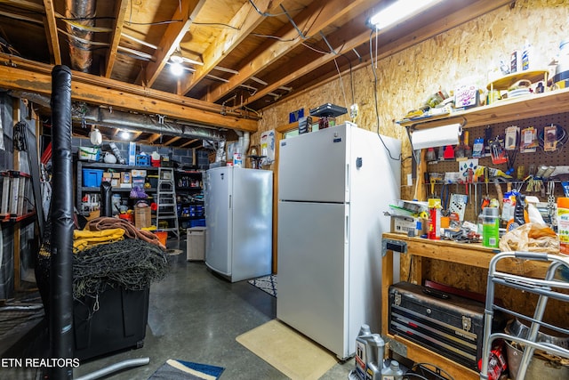 3938 Settlers Trl, Kodak, TN 37764 - unfinished basement featuring freestanding refrigerator and a workshop area