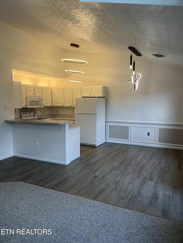 1884 Elmhurst Way, Knoxville, TN 37923 - kitchen featuring white appliances, a peninsula, a textured ceiling, dark wood-style flooring, and decorative light fixtures