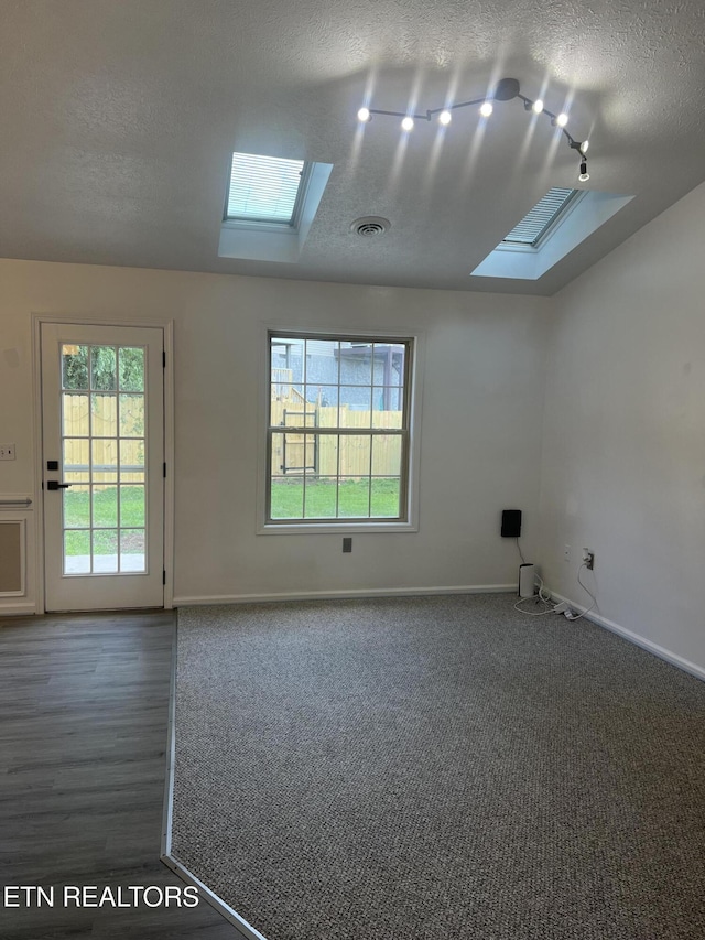 1884 Elmhurst Way, Knoxville, TN 37923 - unfurnished room with a skylight, a textured ceiling, and vaulted ceiling