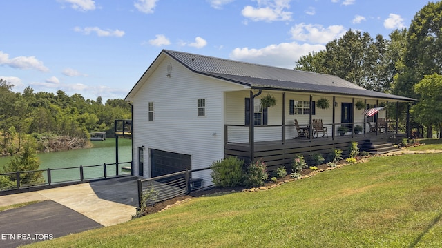 1033 Sunset View Rd, Sevierville, TN 37876 - view of front of house with concrete driveway, a garage, a water view, a metal roof, and covered porch