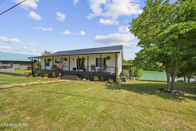 1033 Sunset View Rd, Sevierville, TN 37876 - view of front of home featuring a porch, a front yard, a metal roof, and a water view