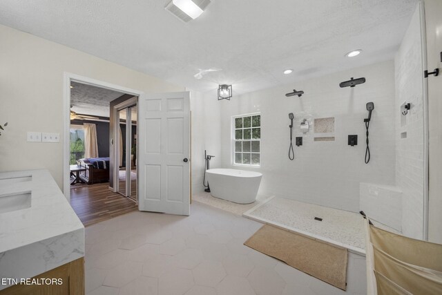 1033 Sunset View Rd, Sevierville, TN 37876 - bathroom with walk in shower, a soaking tub, double vanity, and recessed lighting