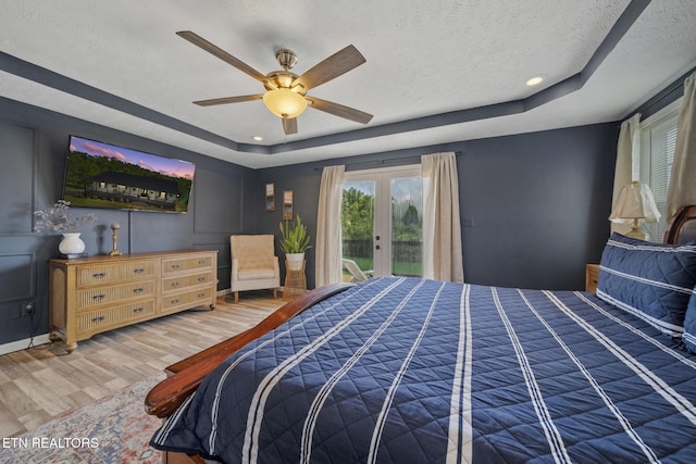 1033 Sunset View Rd, Sevierville, TN 37876 - bedroom featuring a tray ceiling, wood finished floors, access to exterior, french doors, and a textured ceiling