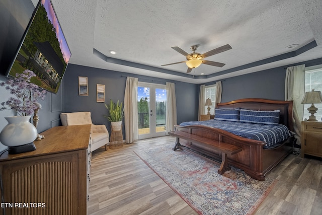 1033 Sunset View Rd, Sevierville, TN 37876 - bedroom with a tray ceiling, a textured ceiling, access to exterior, wood finished floors, and french doors