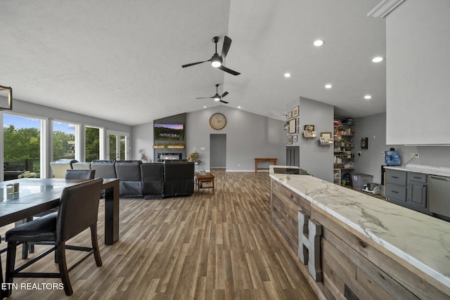 1033 Sunset View Rd, Sevierville, TN 37876 - dining area featuring a glass covered fireplace, wood finished floors, a ceiling fan, vaulted ceiling, and recessed lighting
