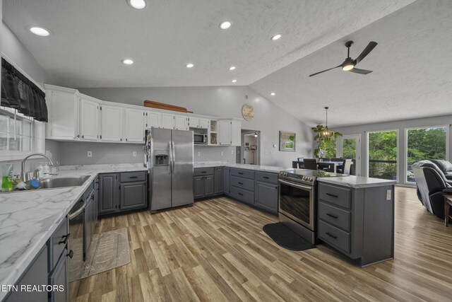 1033 Sunset View Rd, Sevierville, TN 37876 - kitchen with gray cabinets, stainless steel appliances, a ceiling fan, white cabinets, and vaulted ceiling