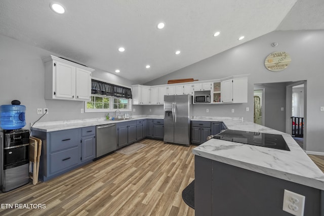 1033 Sunset View Rd, Sevierville, TN 37876 - kitchen featuring stainless steel appliances, a peninsula, light wood-style flooring, open shelves, and recessed lighting