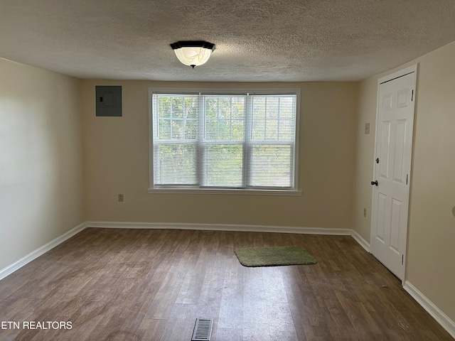 278 Buell Hill Rd, Pineville, KY 40977 - empty room featuring wood finished floors, electric panel, and a textured ceiling