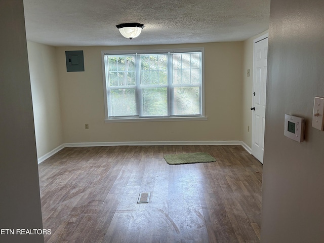 278 Buell Hill Rd, Pineville, KY 40977 - spare room with electric panel, wood finished floors, and a textured ceiling