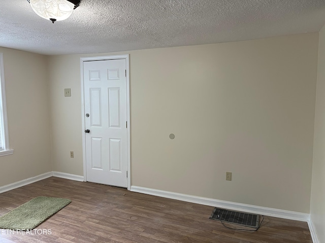 278 Buell Hill Rd, Pineville, KY 40977 - unfurnished room with dark wood-style flooring and a textured ceiling