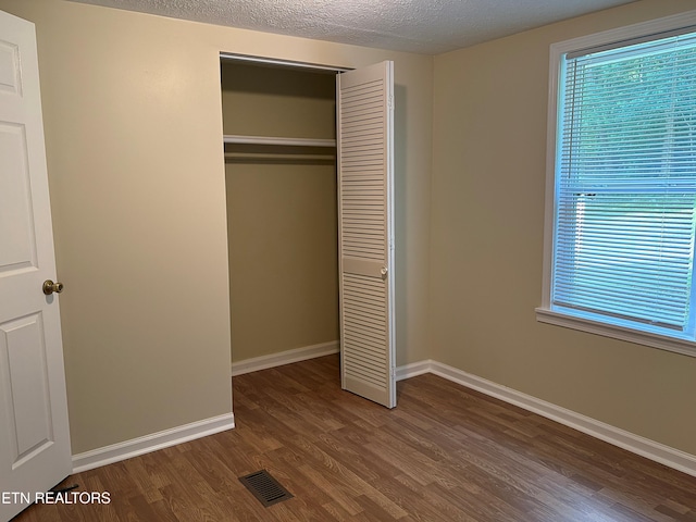 278 Buell Hill Rd, Pineville, KY 40977 - unfurnished bedroom featuring wood finished floors, a closet, and a textured ceiling