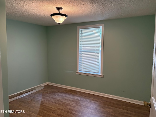 278 Buell Hill Rd, Pineville, KY 40977 - unfurnished room featuring dark wood-style flooring and a textured ceiling