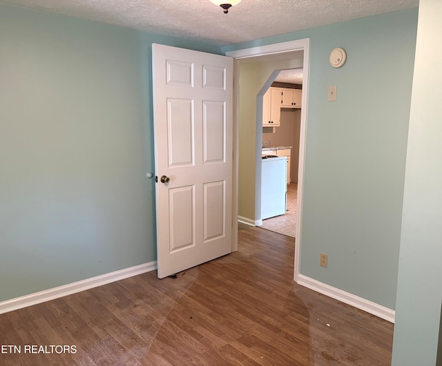 278 Buell Hill Rd, Pineville, KY 40977 - spare room featuring wood finished floors, a textured ceiling, and arched walkways
