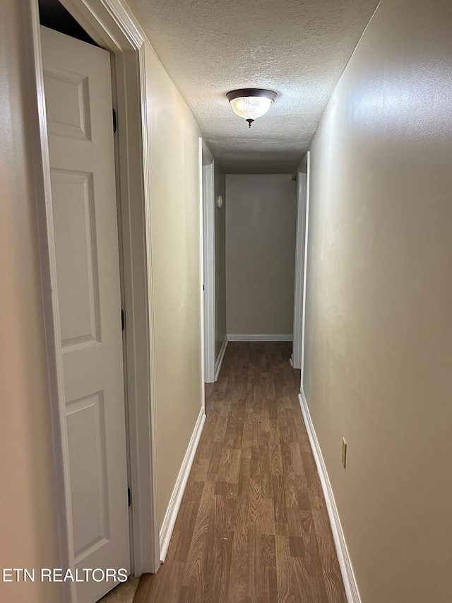 278 Buell Hill Rd, Pineville, KY 40977 - corridor with dark wood finished floors and a textured ceiling