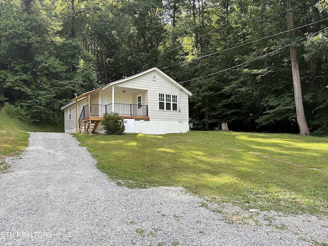 278 Buell Hill Rd, Pineville, KY 40977 - view of front of home featuring gravel driveway, a front lawn, and a forest view