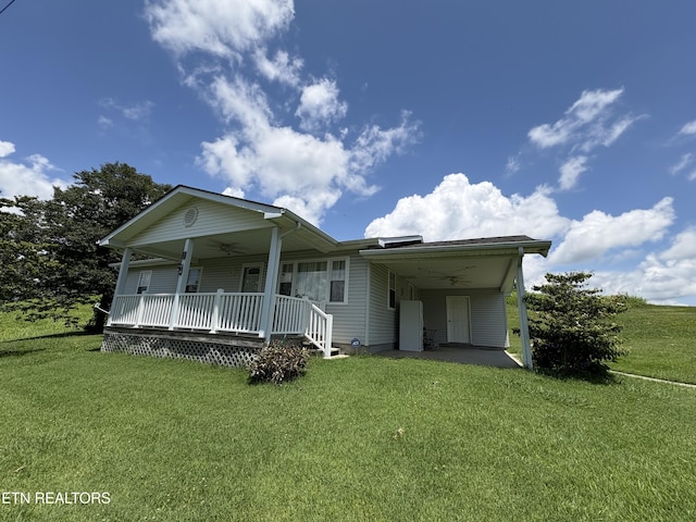 1370 Raven Hill Rd, Tazewell, TN 37879 - view of front of property with ceiling fan, an attached carport, a front lawn, and covered porch